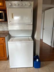 a kitchen with a white stove and a refrigerator at Independent access, one bedroom, one living room, one kitchen and one bathroom in Richmond