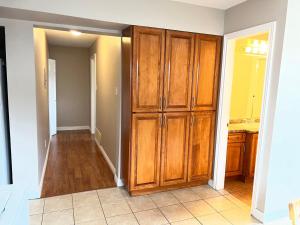 eine Küche mit einem großen Holzschrank in einem Zimmer in der Unterkunft Independent access, one bedroom, one living room, one kitchen and one bathroom in Richmond