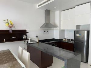 a kitchen with a stainless steel refrigerator and a counter top at Apartaments, Mui Ne, Viet Nam in Phan Thiet