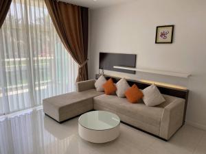 a living room with a couch and a table at Apartaments, Mui Ne, Viet Nam in Phan Thiet