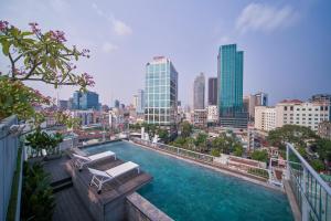 a swimming pool with a view of a city at M Village Tôn Thất Đạm in Ho Chi Minh City