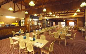 a dining room with tables and chairs in a restaurant at Seabrook Hotel in Somerset