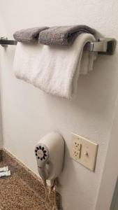 a towel rack with two towels on a wall at OSU 2 Queen Beds Hotel Room 205 Wi-Fi Hot Tub Booking in Stillwater