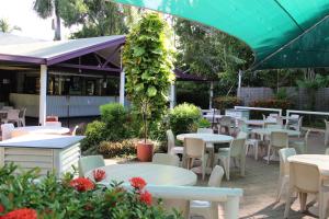 a patio area with tables, chairs and umbrellas at Aurora Kakadu Lodge in Jabiru