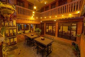 a dining room with a table and chairs in a building at Vajra Guest House & Restaurant in Bhaktapur