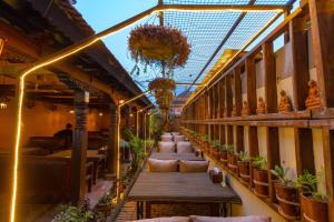 a balcony with a row of chairs and plants at Vajra Guest House & Restaurant in Bhaktapur