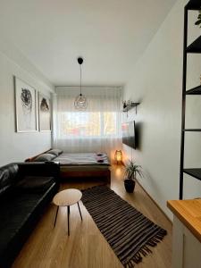 a living room with a couch and a table at Savi Apartment 4 in Pärnu