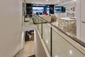 a staircase leading to a living room and a dining room at Edge Apartments in Hamilton Island