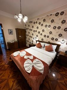 a bedroom with a large bed with two towels on it at Sylt in Sibiu