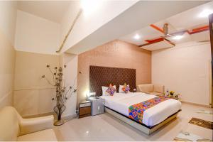 a bedroom with a large bed in a room at FabHotel Prime Rockstar Suites in Kolkata