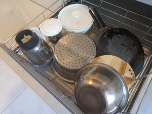 a pile of utensils sitting in a dish drying rack at OSI Apartments Andheri East in Mumbai