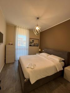a bedroom with a large bed with two glasses on it at [Portello] La casa di Andrea in Milan