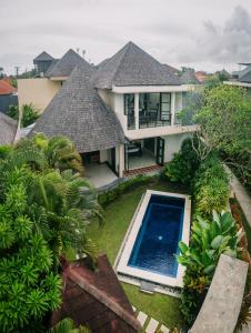 an aerial view of a house with a swimming pool at The Bidadari Villas and Spa Umalas - CHSE Certified in Canggu