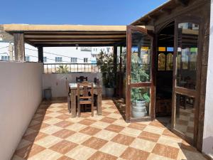 a patio with a table and chairs on a house at Fully equipped villa Near Agadir in Agadir