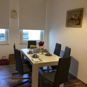 a dining room with a table and chairs at Trabenapartments in Traben-Trarbach +5 photos