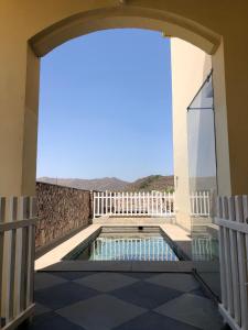 a view from the balcony of a house with a swimming pool at Jai Villa Homestay in Udaipur