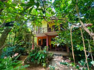 a house in the middle of a forest at Gangadiya Lodge in Sigiriya