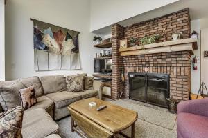 a living room with a couch and a fireplace at Sunrise Timberline G2 in Killington