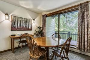 a dining room with a table and chairs and a window at Sunrise Timberline G2 in Killington