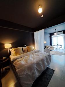 a bedroom with a large bed and a living room at Chi Mei Homestay in Green Island