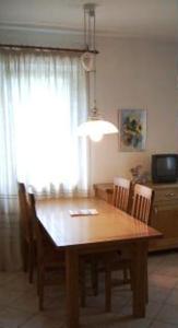 a dining room table with chairs and a window at Pension Angergut in Cermes