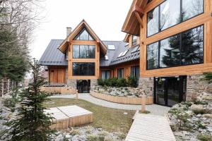 une vue extérieure d'une maison avec une grande maison dans l'établissement WILLA POD KASPROWYM APARTAMENT NUMER 2-Air conditioning, à Zakopane