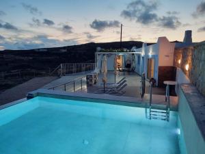a swimming pool on the roof of a house at Villa Otos in Afiartis