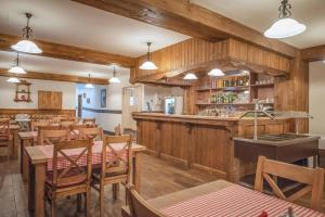 a restaurant with wooden walls and tables and a bar at Hill View Apartment Tatragolf in Veľká Lomnica