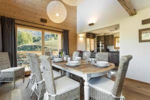 a dining room with a wooden table and chairs at Chalet Grand Roi in La Tzoumaz