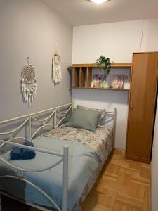 a bedroom with a bed and a shelf at Pokoje do wynajęcia - Podwisłocze 8a in Rzeszów