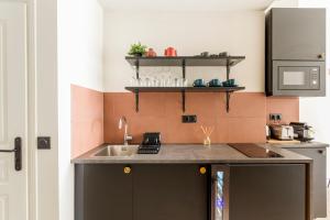 a kitchen with a sink and a counter top at Best Stay Jeuneurs in Paris