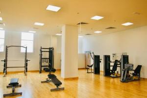 a gym with several treadmills and machines in a room at Best deal in town Yas Island 232WB10 in Abu Dhabi