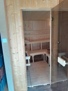 a door into a sauna with a bench in it at Kincsem Vendégház in Szilvásvárad