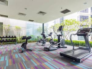 a gym with cardio equipment in a building at Mercu Summer Suites KLCC by Veedu Hauz in Kuala Lumpur