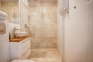 a bathroom with a shower and a sink at HelApart - Rodzinny in Hel