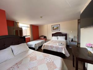 A bed or beds in a room at Antara Hostal