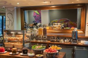 a buffet line with bowls of food in a restaurant at Travelodge Georgetown, Penang in George Town
