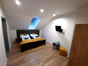 a attic bedroom with a bed and a skylight at BIRD HOUSE in Prešov