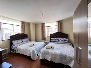A bed or beds in a room at Antara Hostal