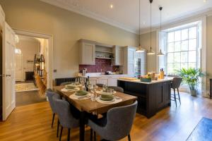 a kitchen and dining room with a table and chairs at Luxury Edinburgh New Town home in Edinburgh