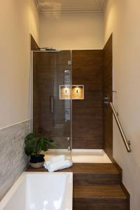 a bathroom with a shower and a tub and a sink at Luxury Edinburgh New Town home in Edinburgh +53 photos