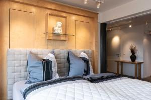 sypialnia z dużym białym łóżkiem z niebieskimi poduszkami w obiekcie SMC Muenster w Münster