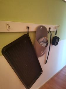 a shelf with a black keyboard and shoes on a wall at Auszeit in Freital