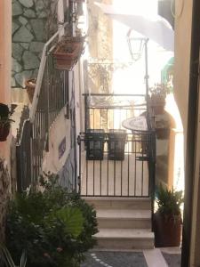 a stairway with a gate and some potted plants at Diamantina Kiss in Diamante