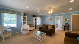 a living room with a couch and a table at LYONS DEN - 3 Bedroom Home home in Jekyll Island