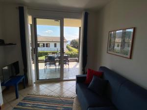 a living room with a couch and a sliding glass door at Melograno in Feriolo in Baveno