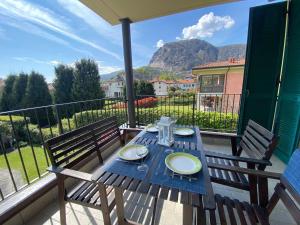 a wooden table with two chairs on a balcony at Melograno in Feriolo in Baveno