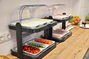 a refrigerator filled with lots of different types of food at Hotel Garni Fischerfleck in Ismaning near Munich in Ismaning