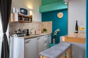 a small kitchen with a blue wall and a counter at Agripas #4 in Jerusalem