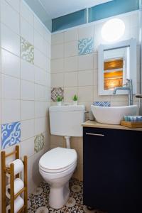 a bathroom with a toilet and a sink at Agripas #4 in Jerusalem